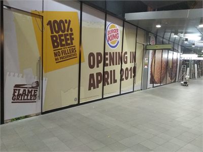 Burger King shopfront hoarding printed and installed across a mall unit before opening