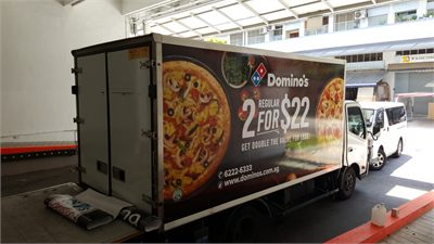 Domino's Pizza delivery vehicle carrying printed wrap graphics
