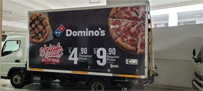 Delivery truck with printed wrap graphics along the full length of the box body
